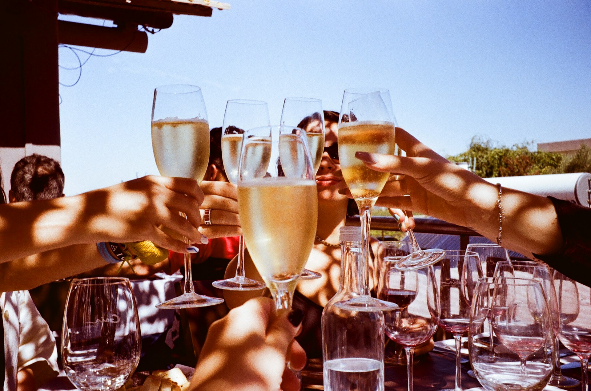 Sparkling wine glasses raised outdoors
