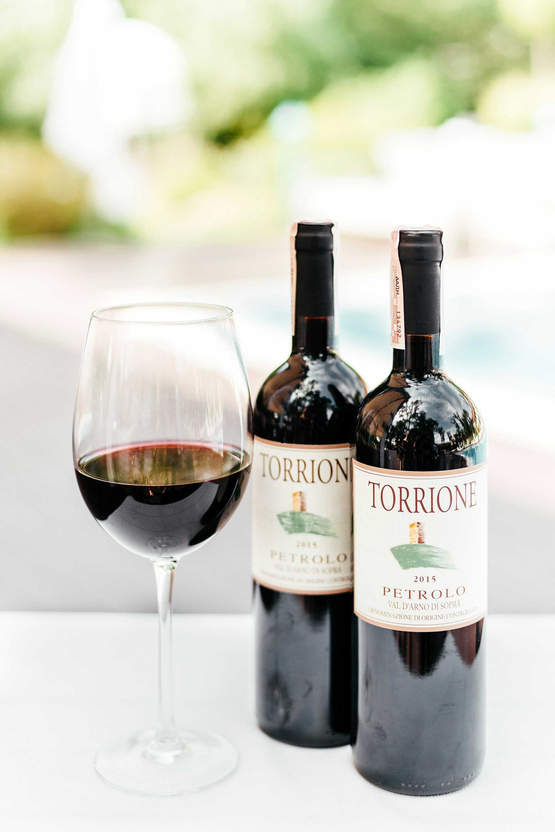 Bottles and a poured glass of wine